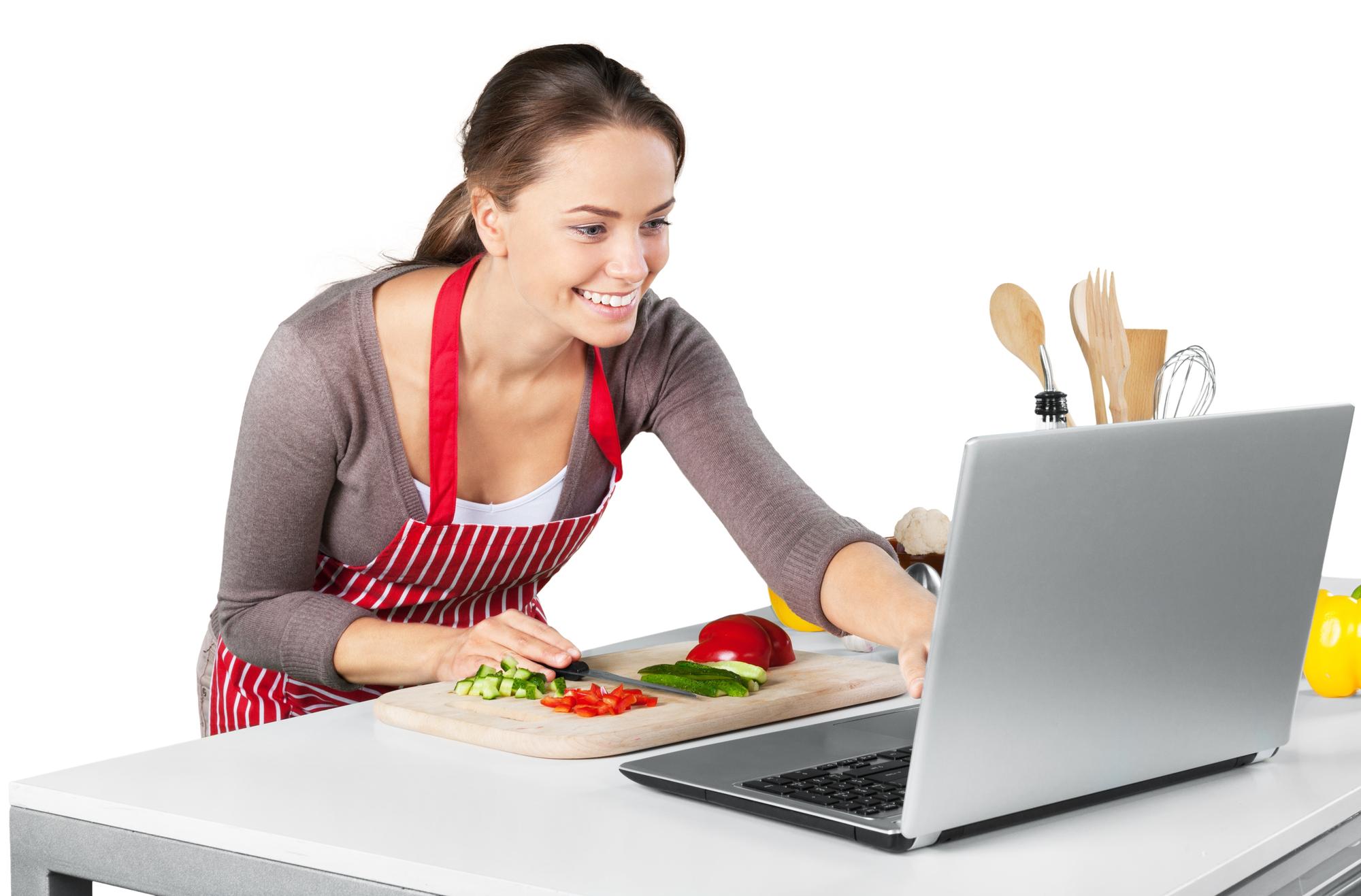 Cook teaching online with laptop in kitchen
