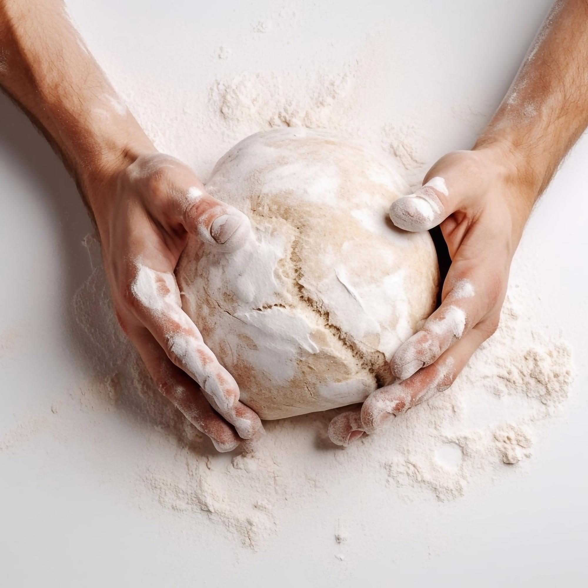 Hands kneading dough during an online class